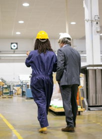 rear-view-boss-standing-factory-listening-plant-worker.jpg